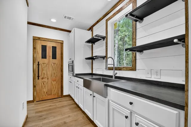 a kitchen with granite countertop a sink and a stove