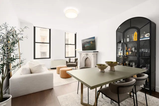 a living room with furniture a large window and a flat screen tv