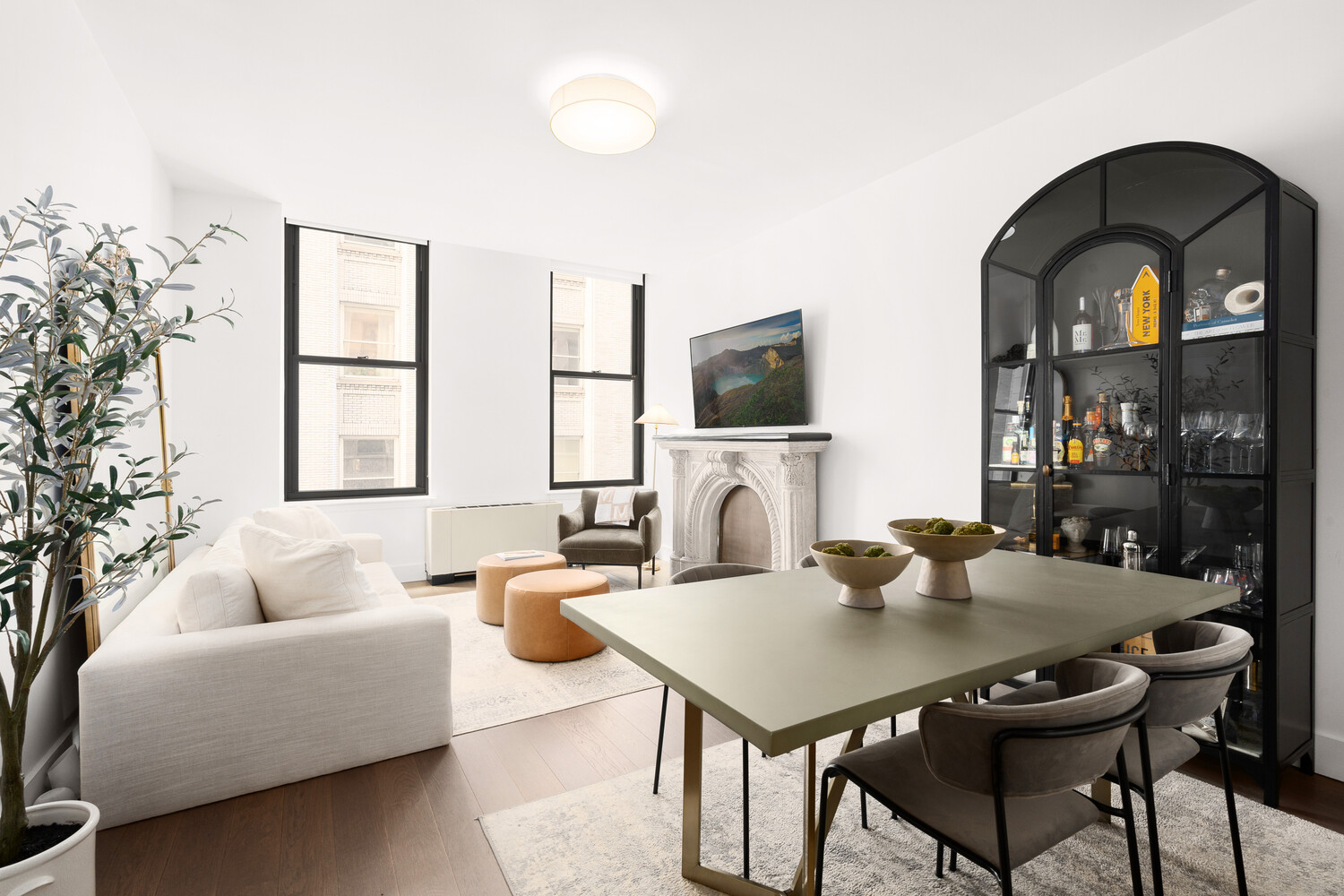 a living room with furniture a large window and a flat screen tv