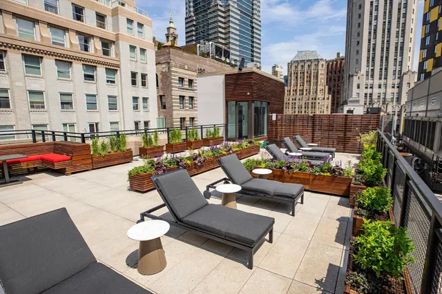 a view of a patio with couches and table and chairs and potted plants