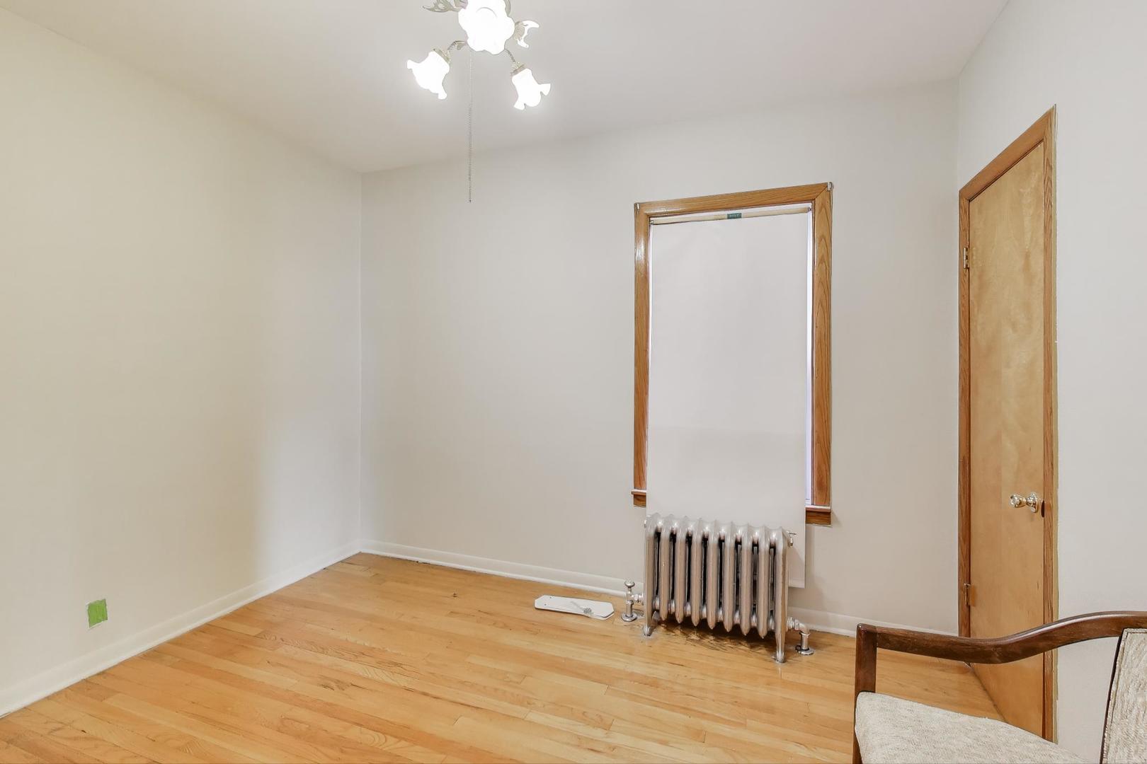 3958 South Rockwell Street Chicago, IL 60632 - Photo 13 of 38 a view of an empty room with wooden floor and a window