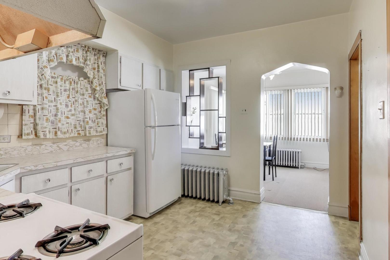 3958 South Rockwell Street Chicago, IL 60632 - Photo 8 of 38 a hallway with a sink and a refrigerator