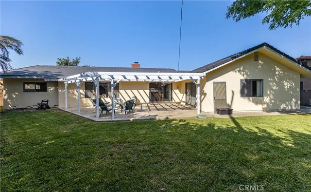 a view of a patio with a table chairs and a backyard