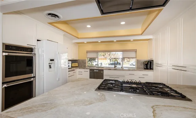 a view of a refrigerator in kitchen and wooden floor