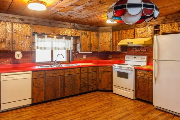 a kitchen with stainless steel appliances a stove a sink and a refrigerator