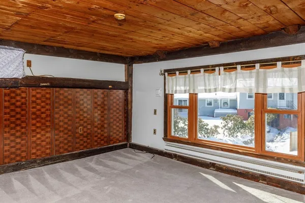 a view of a room with wooden floor and a window