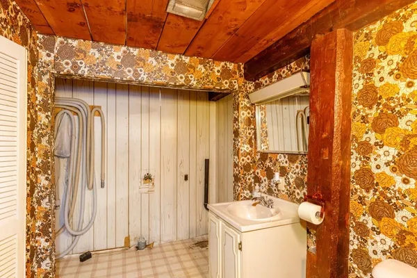 a bathroom with a sink a toilet and shower curtain