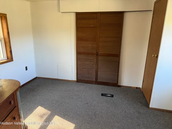 a view of an empty room and hallway