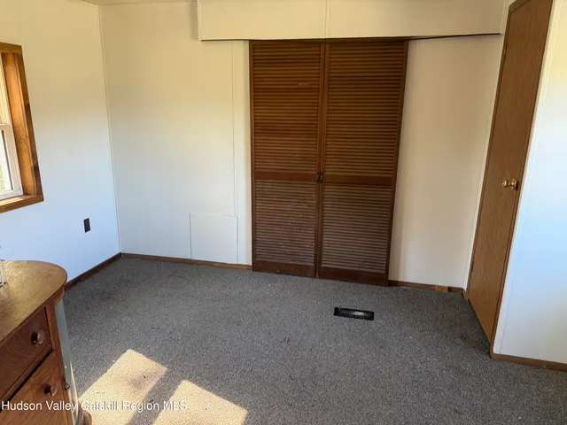 a view of an empty room and hallway