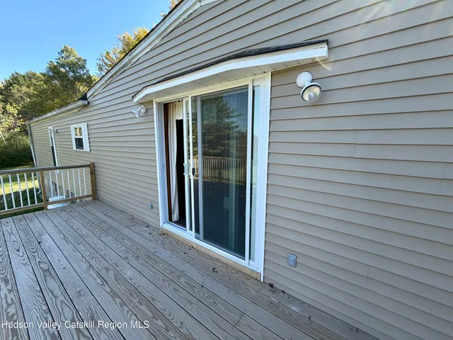a view of a house with wooden deck