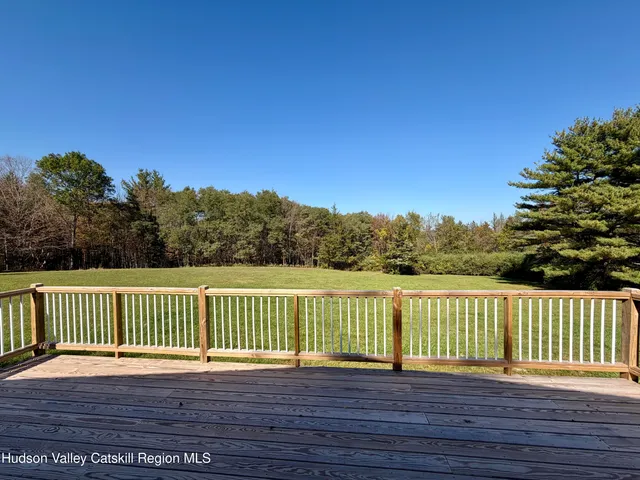 a view of a wooden deck with a yard