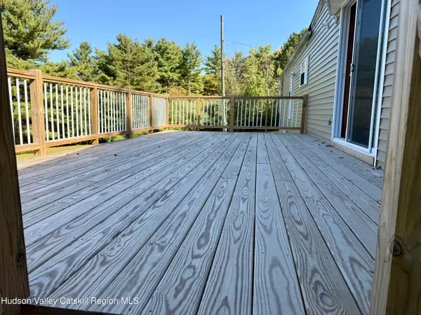 a view of balcony with wooden floor and fence