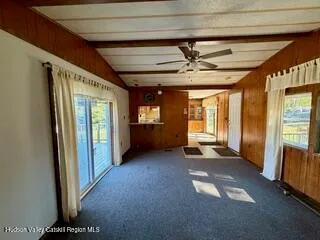 a view of a room with furniture and windows