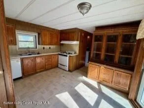 a kitchen with stainless steel appliances granite countertop a sink and a stove