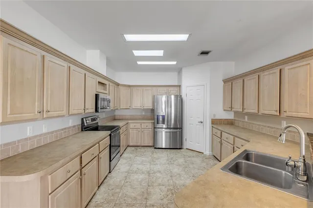 a kitchen with a sink stove and refrigerator