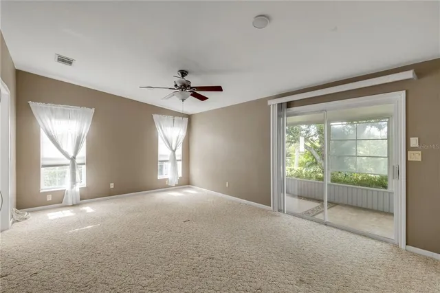 a view of a livingroom with a ceiling fan and window