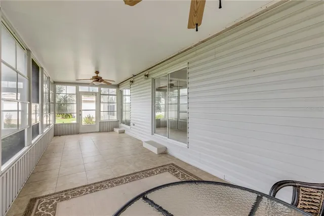 a view of a balcony with wooden floor and lake
