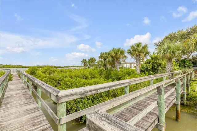 an aerial view of a swimming pool with outdoor seating and yard