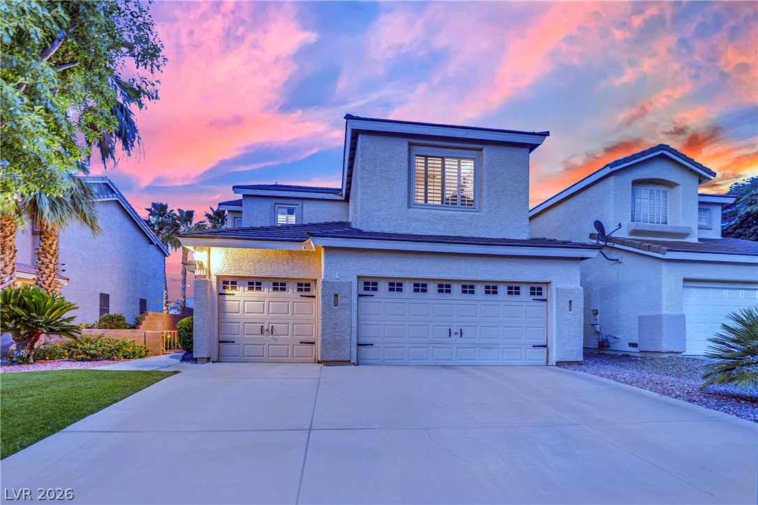 1724 Millstream Way Henderson, NV 89074 - Photo 43 of 60 A striking desert residence boasts a well-maintained driveway leading to two spacious garages.