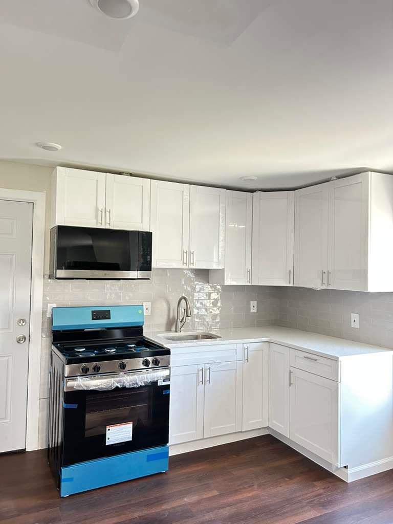 a kitchen with stainless steel appliances a stove a microwave and cabinets