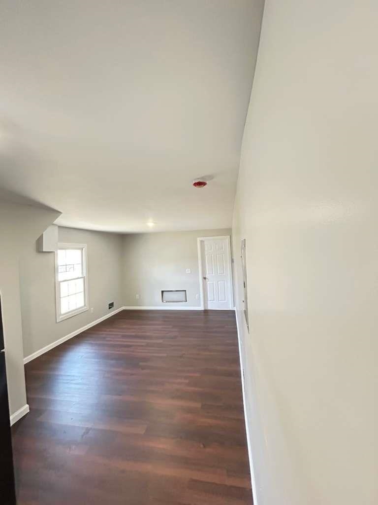 8 Hampton Street, Unit B Newton, NJ 07860 - Photo 2 of 7 an empty room with wooden floor and windows