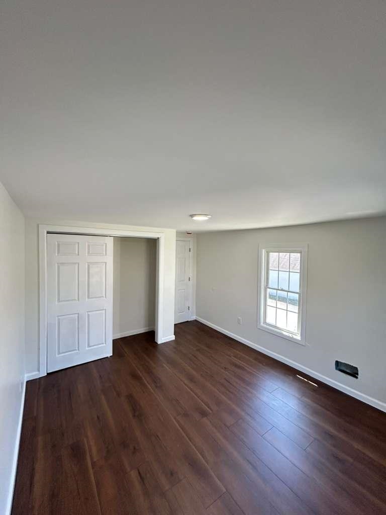 8 Hampton Street, Unit B Newton, NJ 07860 - Photo 4 of 7 an empty room with wooden floor and window