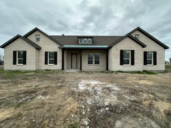 a front view of a house with yard