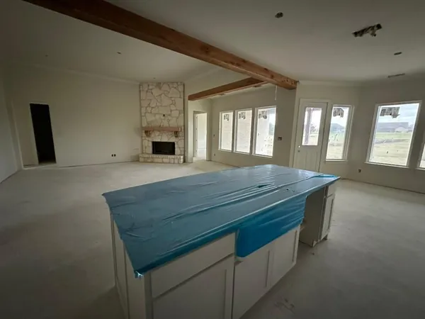 a room with pool table and windows