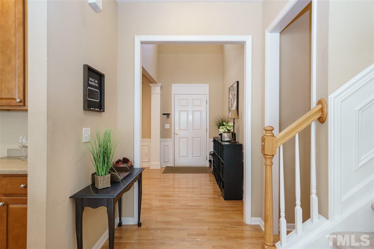 5409 Brandy Bay Road Raleigh, NC 27613 - Photo 2 of 25 a view of a hallway with wooden floor and a potted plant