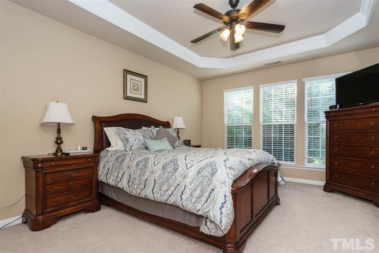 5409 Brandy Bay Road Raleigh, NC 27613 - Photo 12 of 25 a bedroom with a bed and a flat tv screen on dresser
