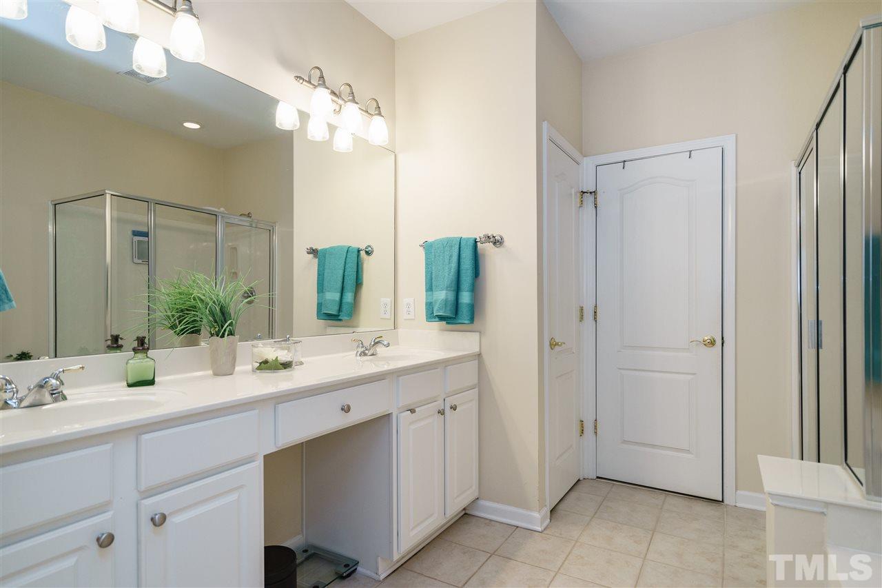 5409 Brandy Bay Road Raleigh, NC 27613 - Photo 13 of 25 a bathroom with a double vanity sink and mirror