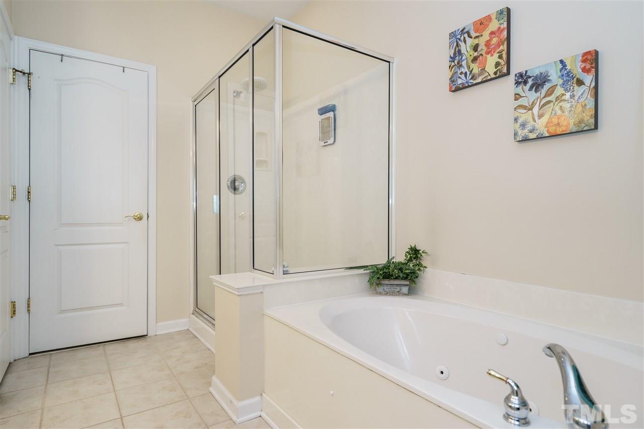 5409 Brandy Bay Road Raleigh, NC 27613 - Photo 14 of 25 a bathroom with a bathtub and shower