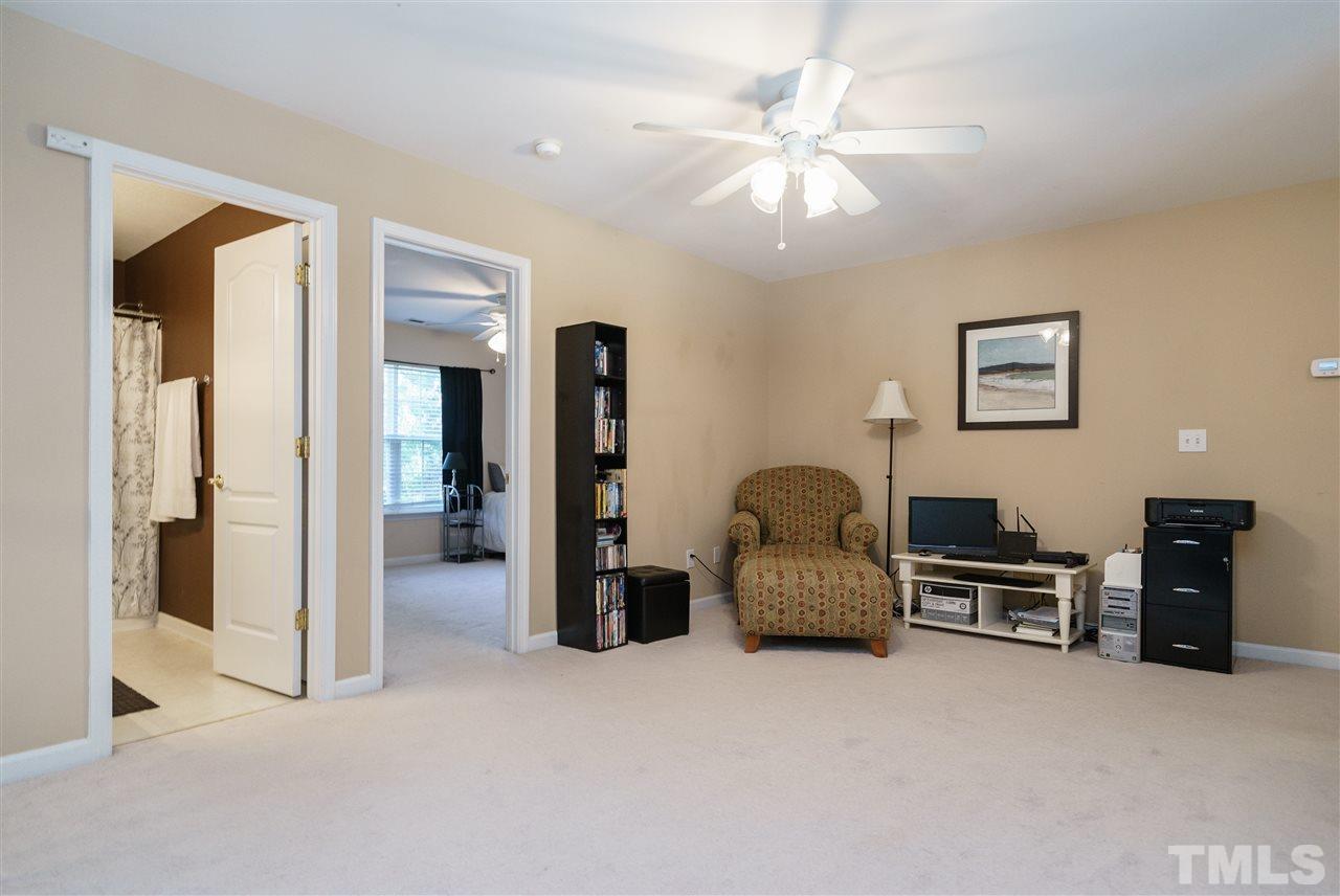5409 Brandy Bay Road Raleigh, NC 27613 - Photo 16 of 25 a bedroom with furniture and a chandelier