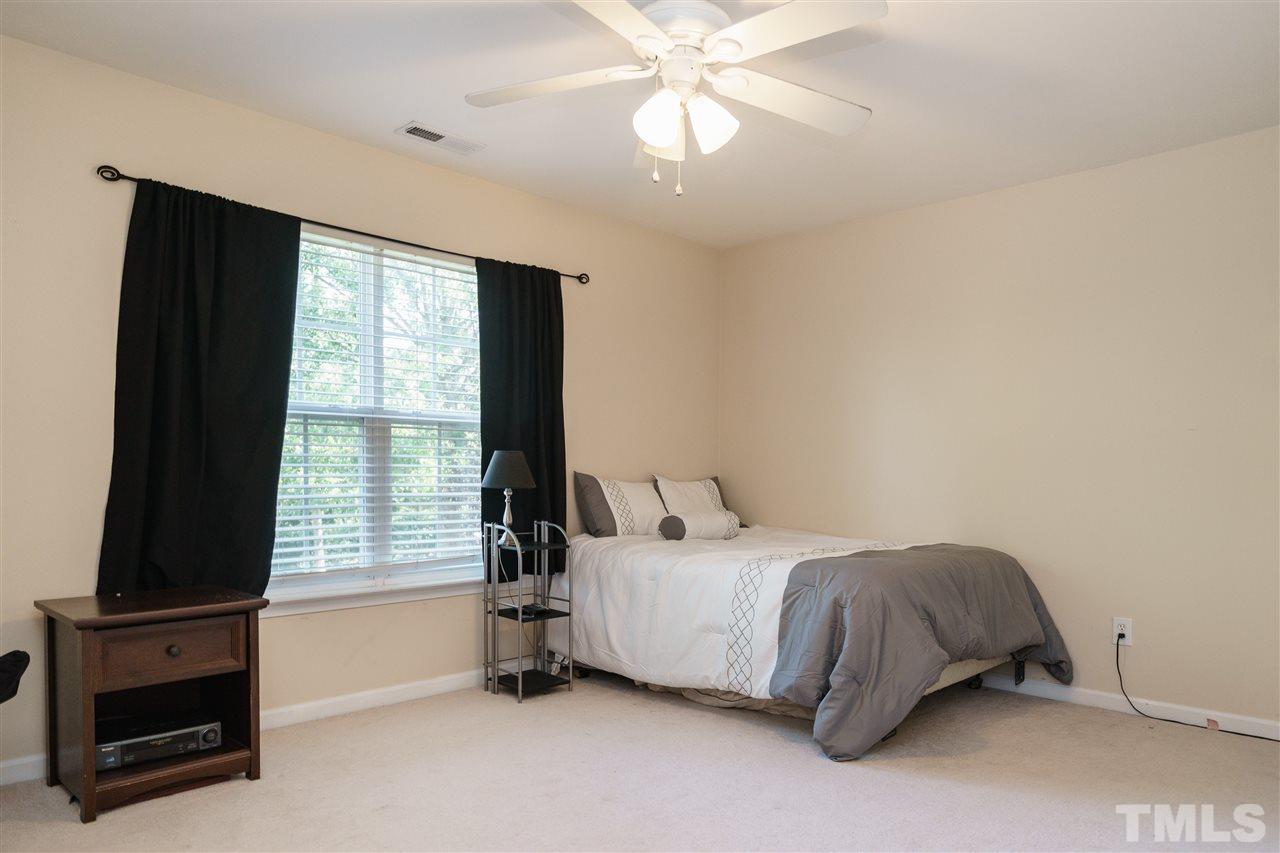 5409 Brandy Bay Road Raleigh, NC 27613 - Photo 18 of 25 a bedroom with a bed and a window