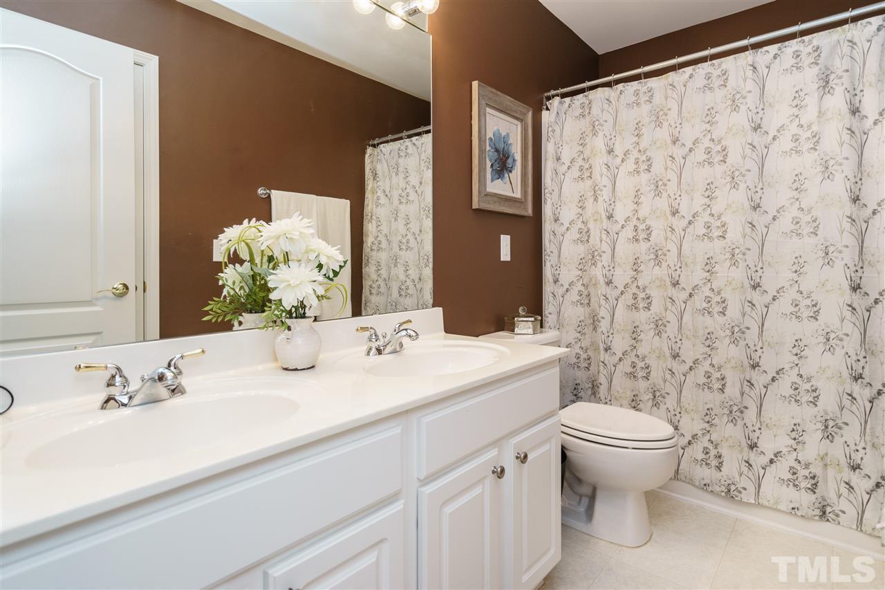 5409 Brandy Bay Road Raleigh, NC 27613 - Photo 19 of 25 a bathroom with a sink and a mirror