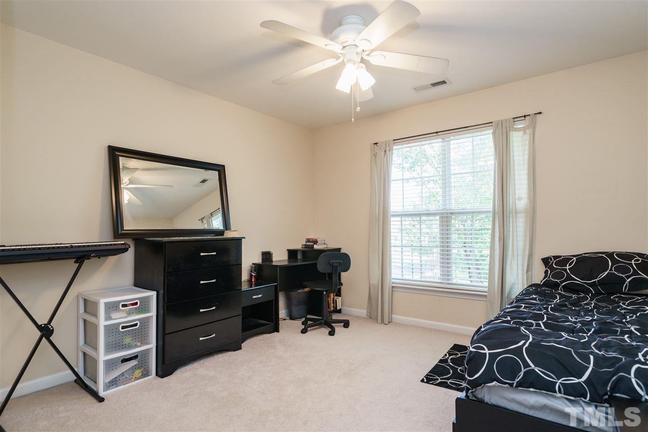 5409 Brandy Bay Road Raleigh, NC 27613 - Photo 20 of 25 a bedroom with furniture and a flat screen tv