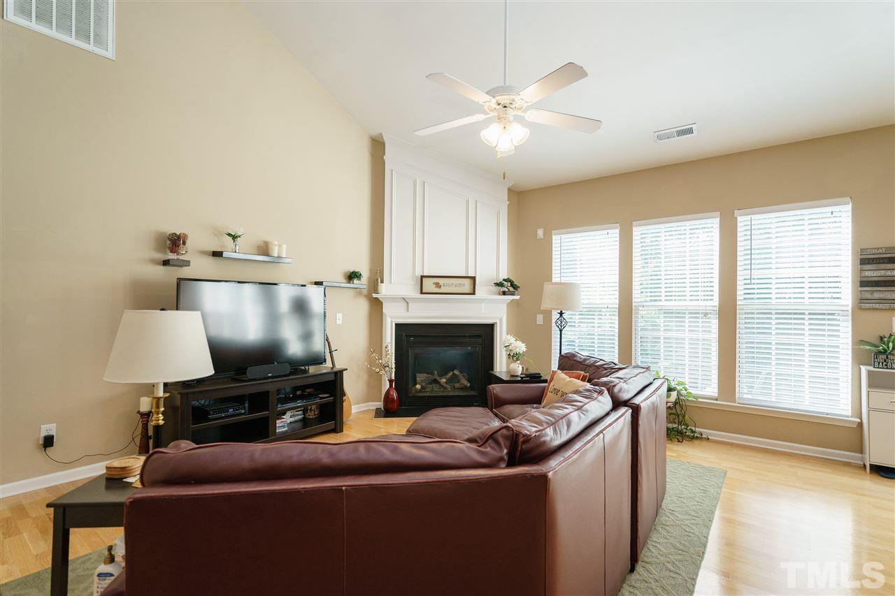 5409 Brandy Bay Road Raleigh, NC 27613 - Photo 4 of 25 a living room with furniture and a fireplace