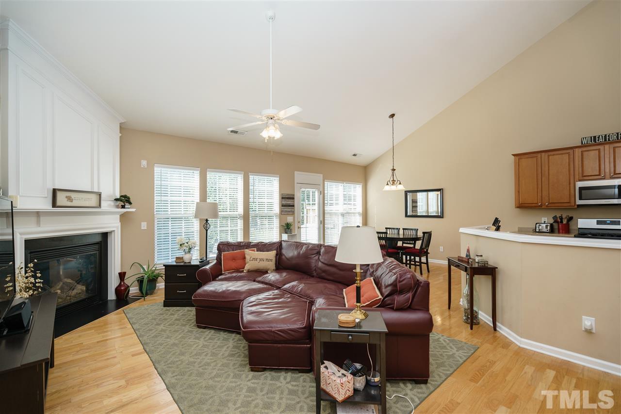 5409 Brandy Bay Road Raleigh, NC 27613 - Photo 5 of 25 a living room with furniture a fireplace and a flat screen tv