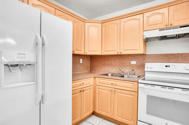 a kitchen with a white cabinets and white appliances