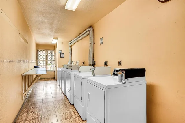 a view of washer and dryer with wooden floor