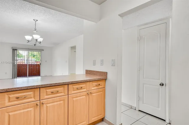 a view of a kitchen with granite countertop cabinets