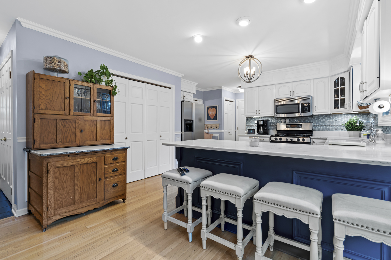 1713 East Thomas Road Wheaton, IL 60187 - Photo 18 of 55 a kitchen with stainless steel appliances granite countertop a stove a sink a microwave a refrigerator cabinets and chairs