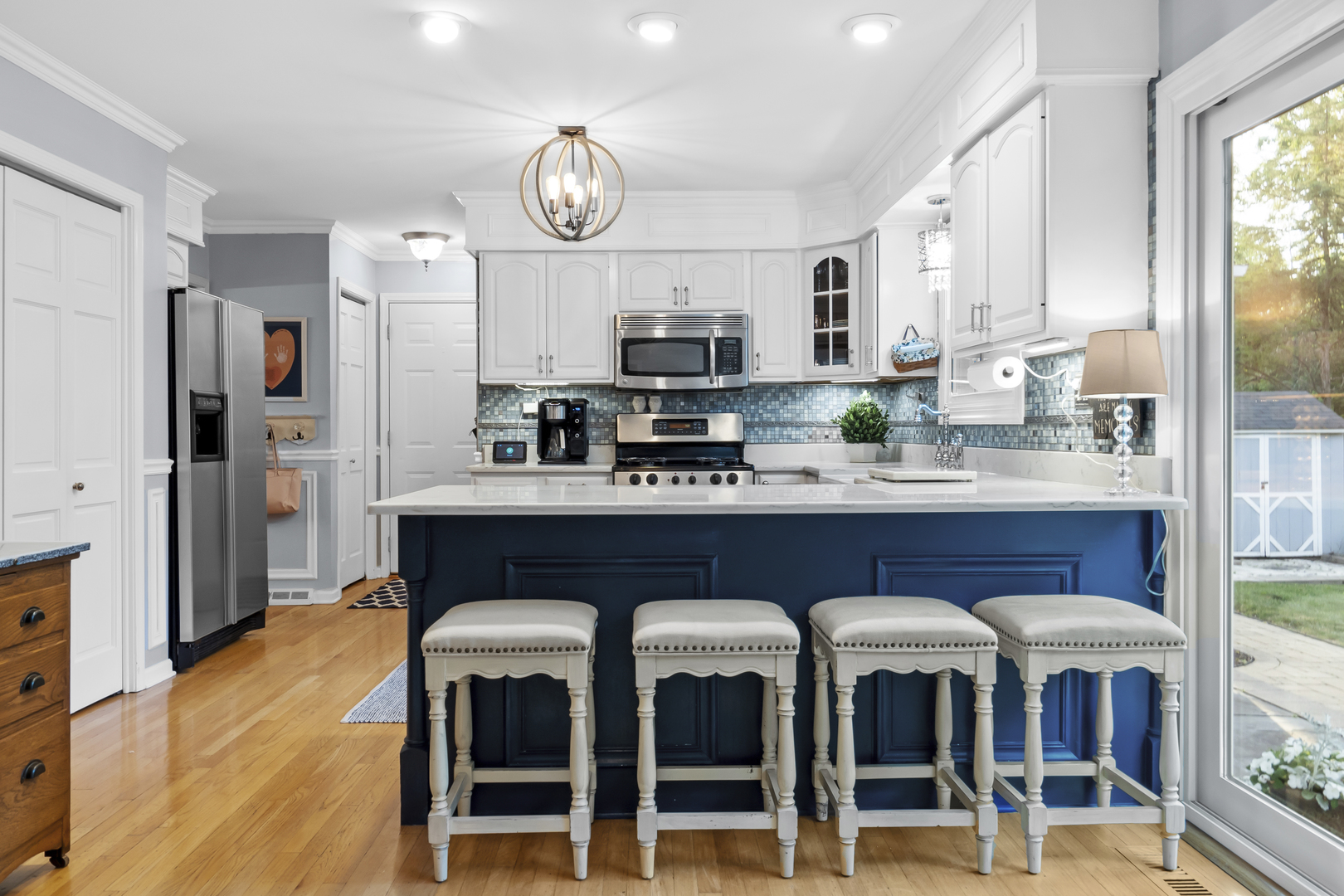 1713 East Thomas Road Wheaton, IL 60187 - Photo 19 of 55 a kitchen with stainless steel appliances granite countertop a table chairs sink and cabinets