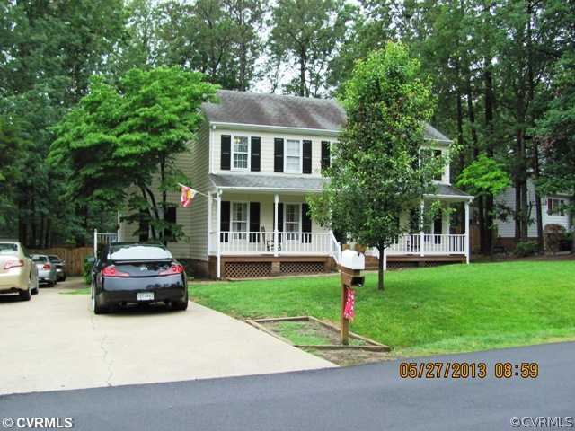 3507 Ludgate Road Chester, VA 23831 - Photo 2 of 12 a front view of a house with a garden and trees