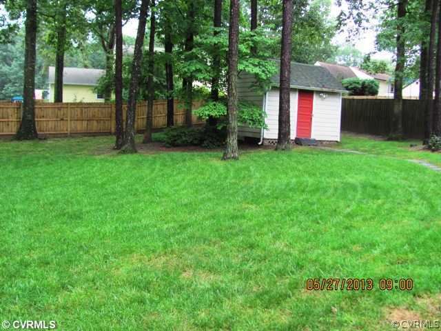 3507 Ludgate Road Chester, VA 23831 - Photo 4 of 12 a view of a backyard with a small cabin