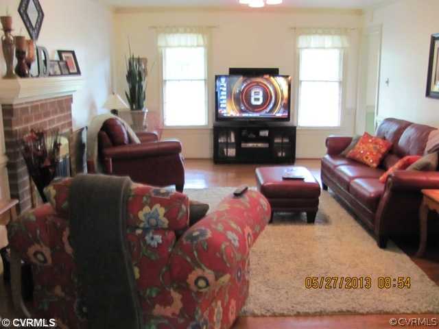3507 Ludgate Road Chester, VA 23831 - Photo 5 of 12 a living room with furniture a fireplace and a flat screen tv