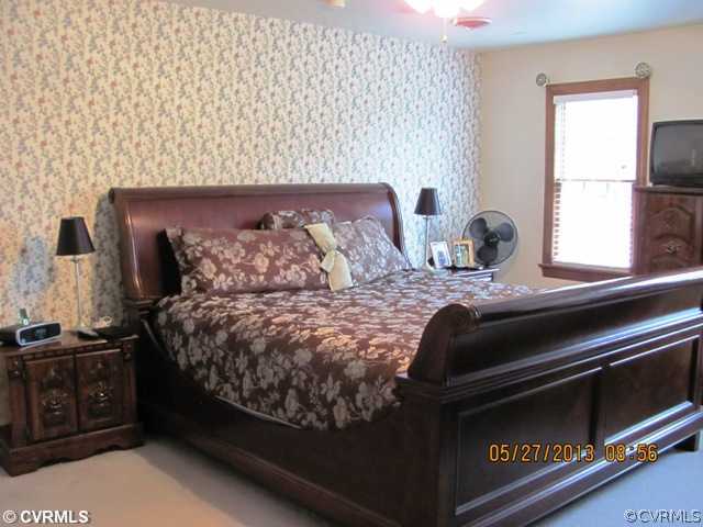 3507 Ludgate Road Chester, VA 23831 - Photo 10 of 12 a bed sitting in a bedroom next to a window