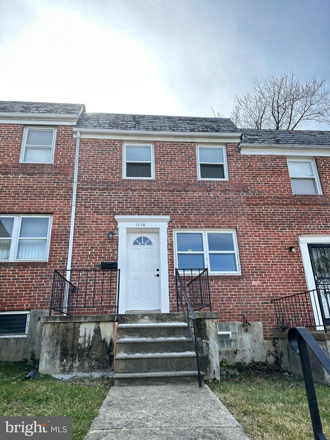 1038 Wedgewood Road Baltimore, MD 21229 - Photo 2 of 12 a front view of a house with a garden
