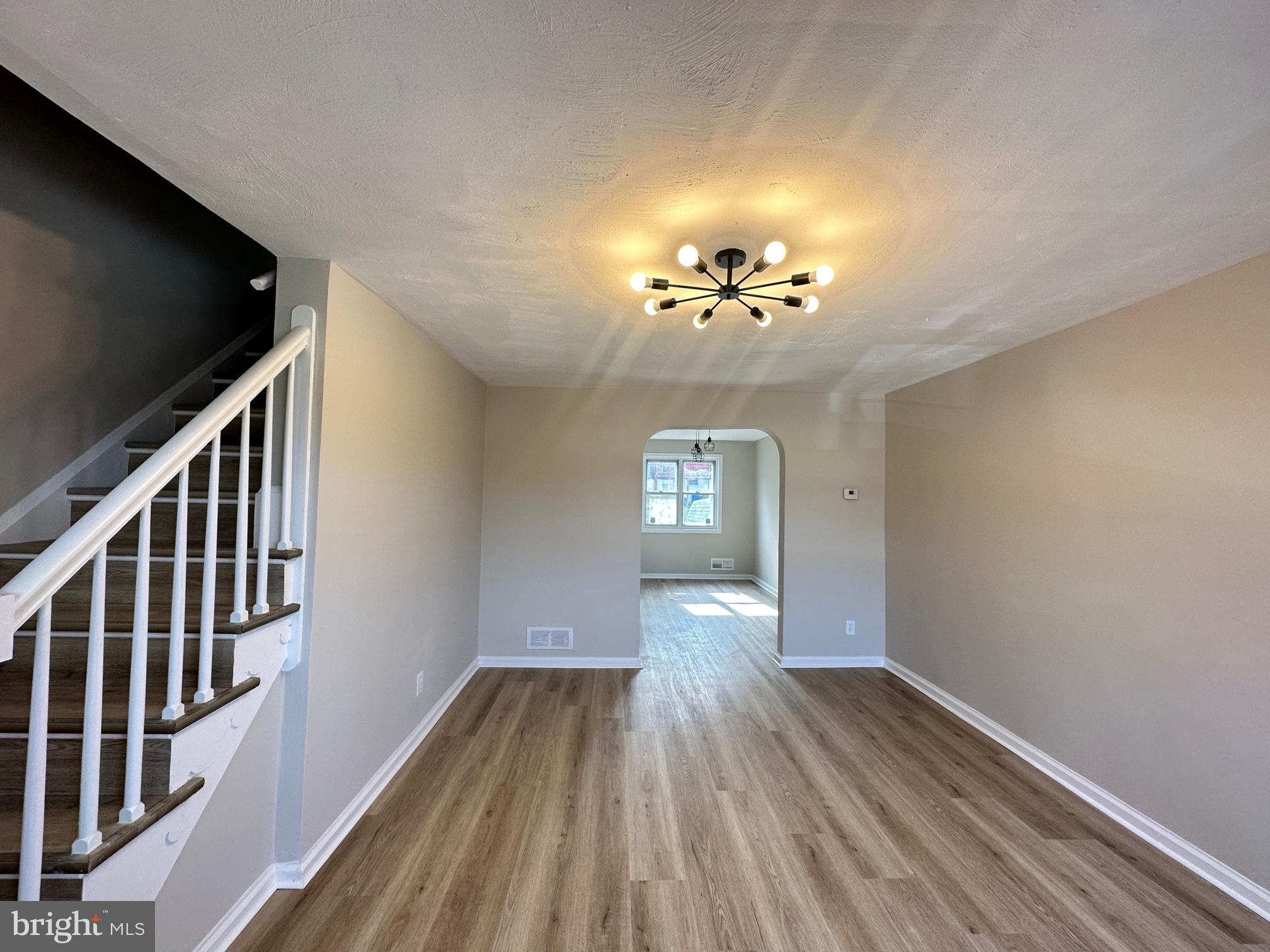 1038 Wedgewood Road Baltimore, MD 21229 - Photo 3 of 12 a view of livingroom with hardwood floor and stairs