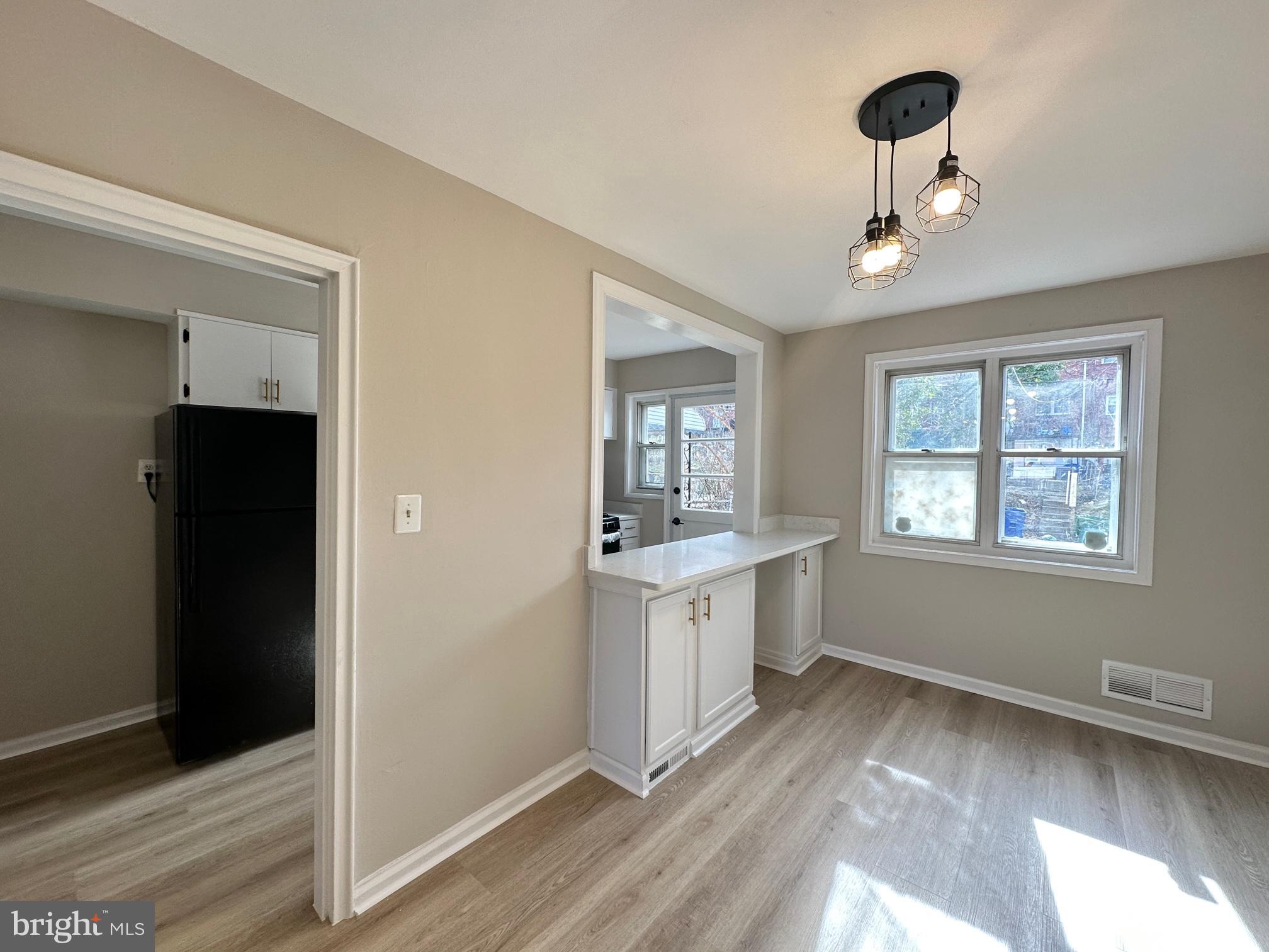 1038 Wedgewood Road Baltimore, MD 21229 - Photo 4 of 12 a view of an empty room and window